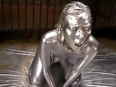 Girl covered in multiple layers of paint having orgasm
